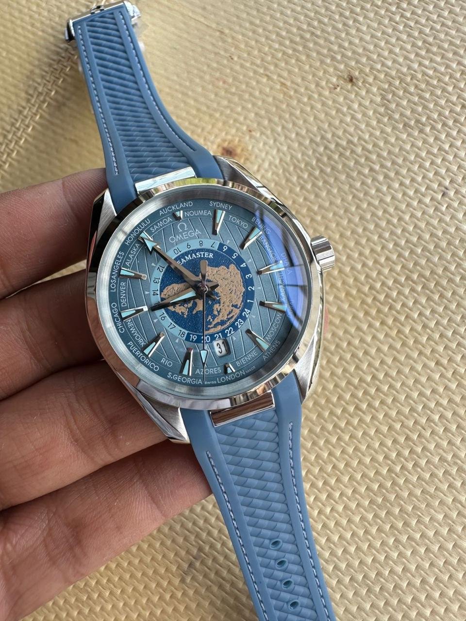 Blue dial silver dive watch with yellow markers and stainless steel mesh bracelet
